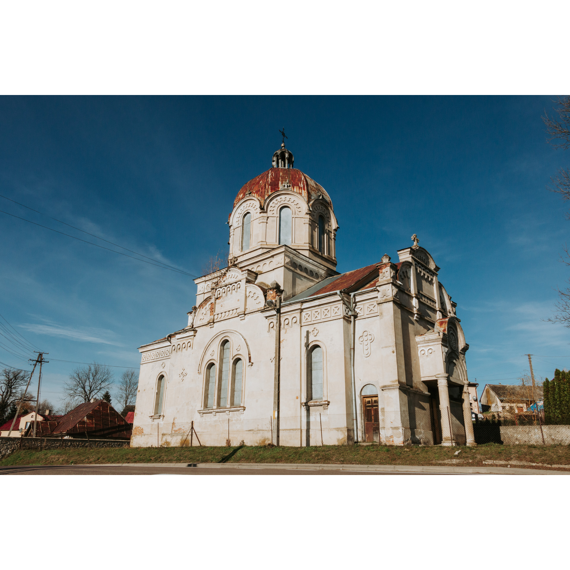 A bright, brick Orthodox church with decorative windows and a dome