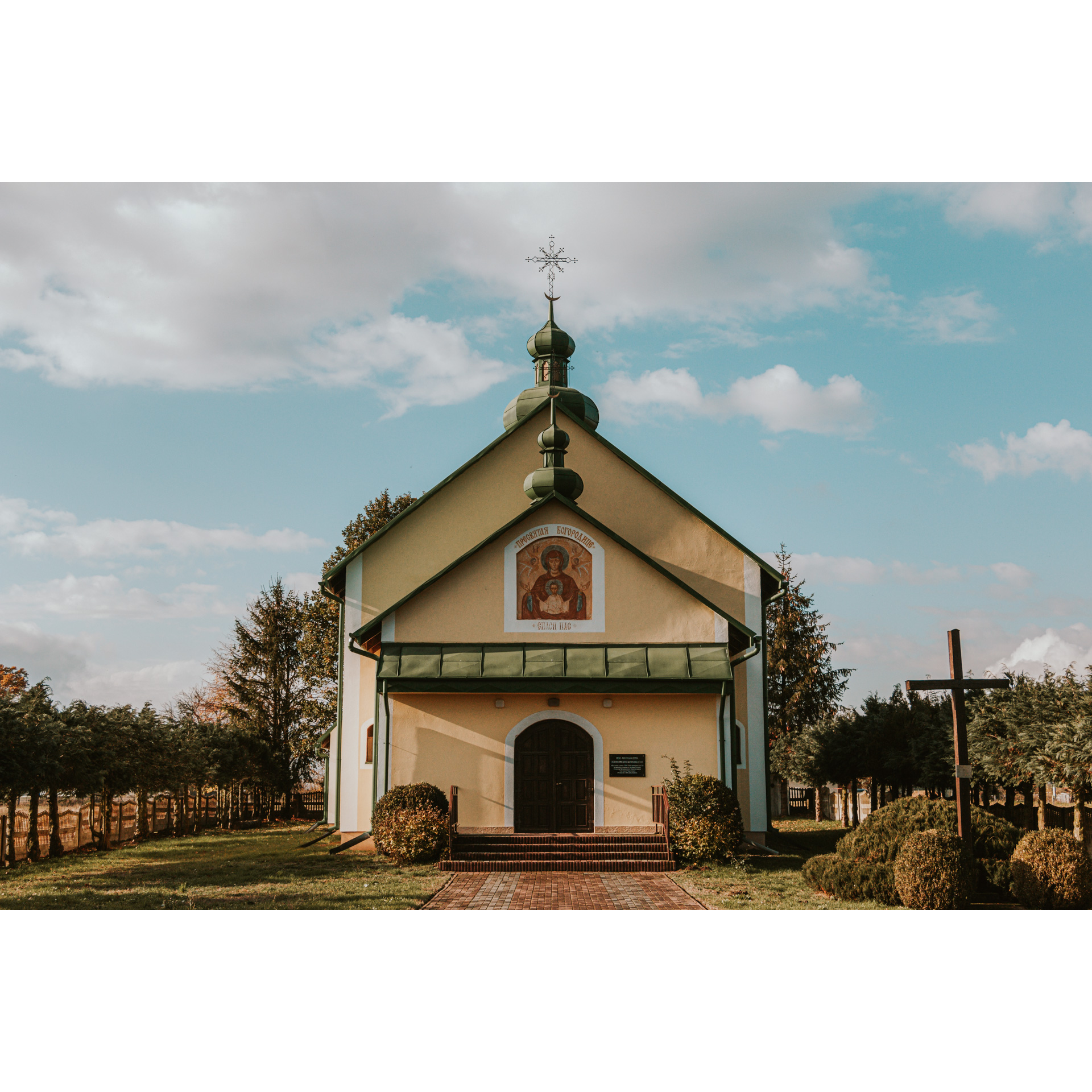 Entrance to the church with a decorative facade with a painted holy image