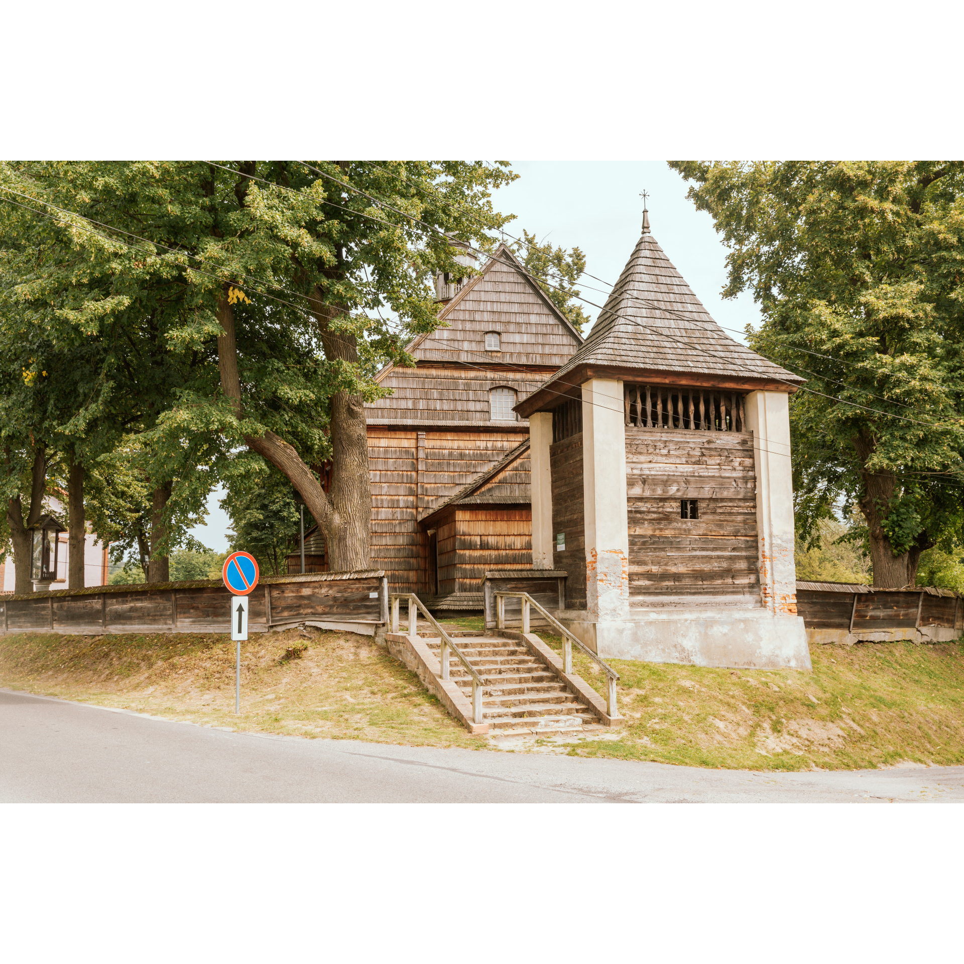 Wooden church among green trees