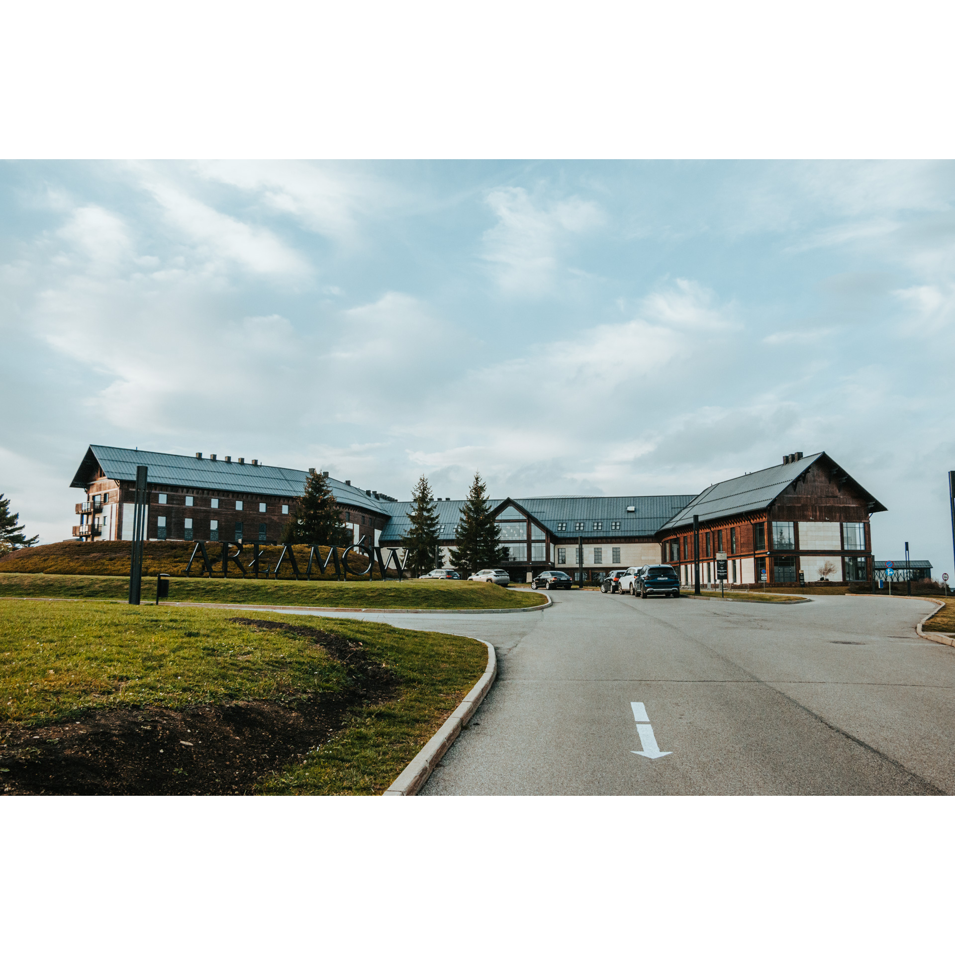 Asphalt road leading to a large hotel