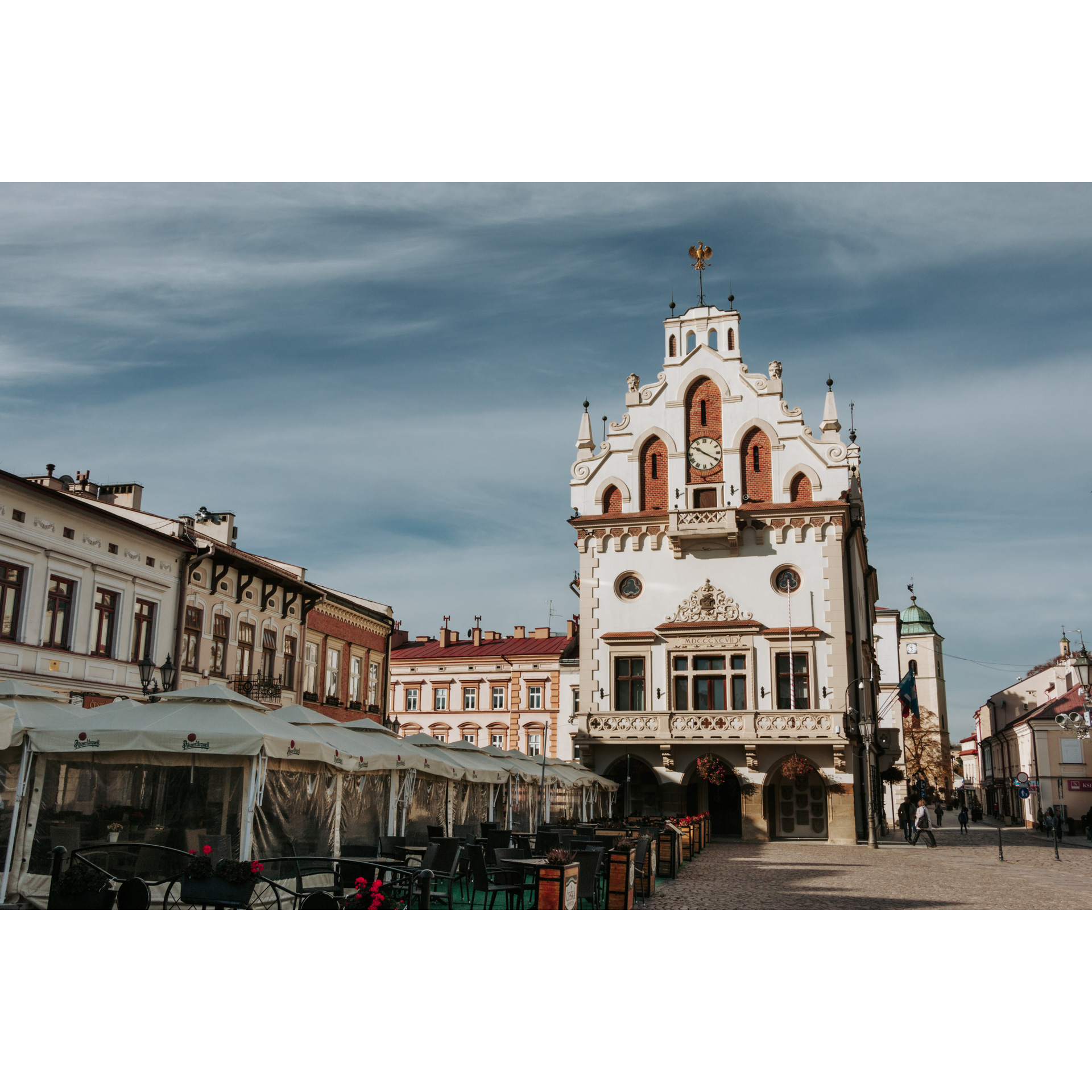 A view from behind the foil tents on the town hall with a decorative facade and a balcony