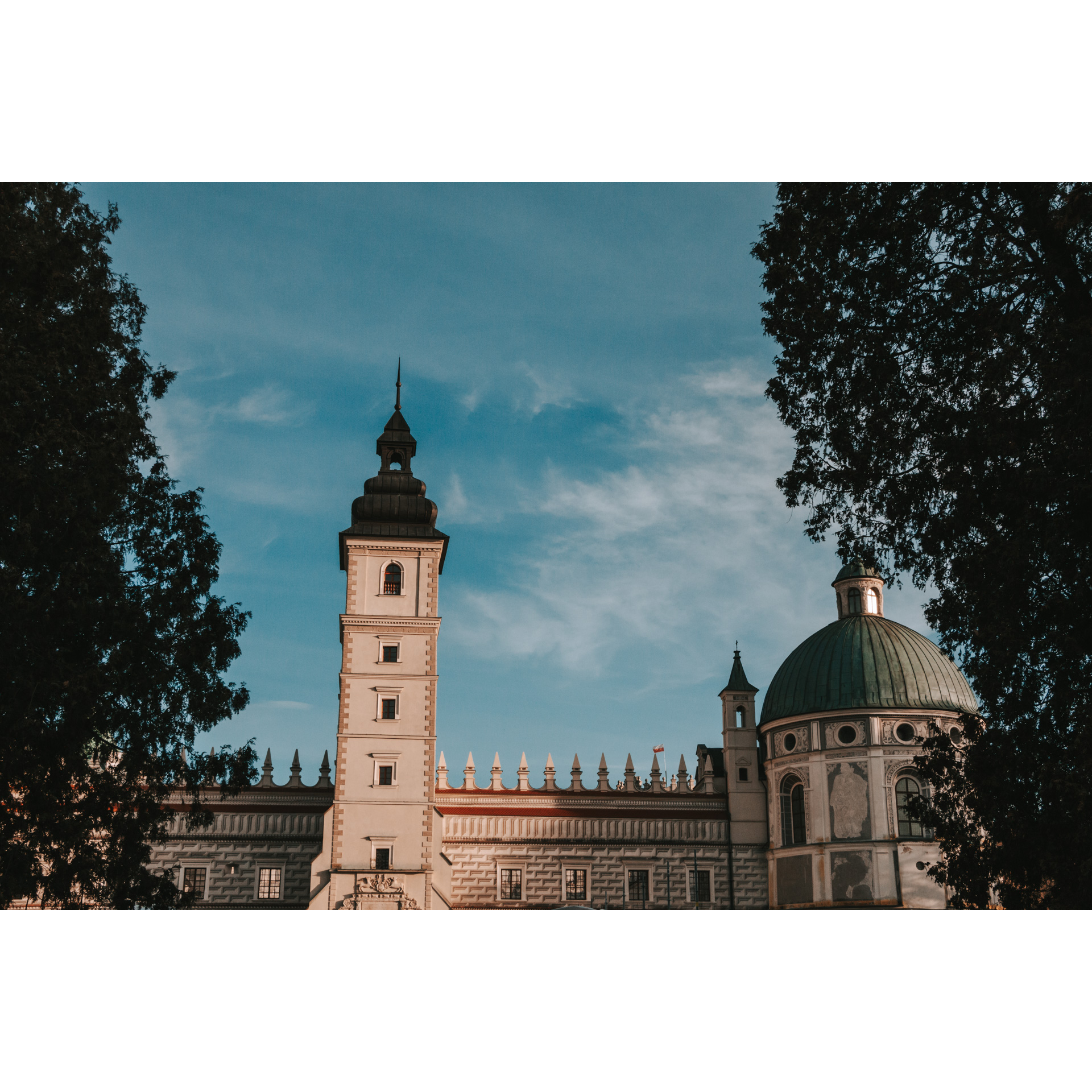 Tower and dome of a castle with trees on the sides