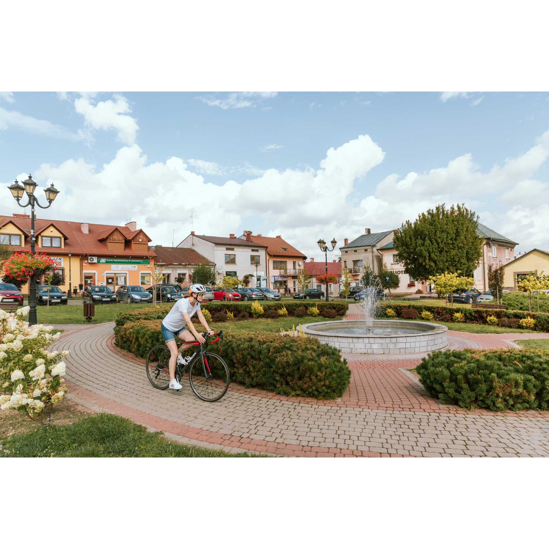 Cyclist, buildings and fountain