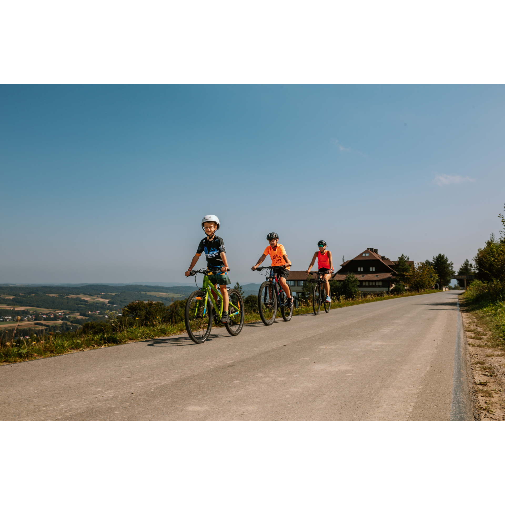 Cyclists and a wooden house in the background