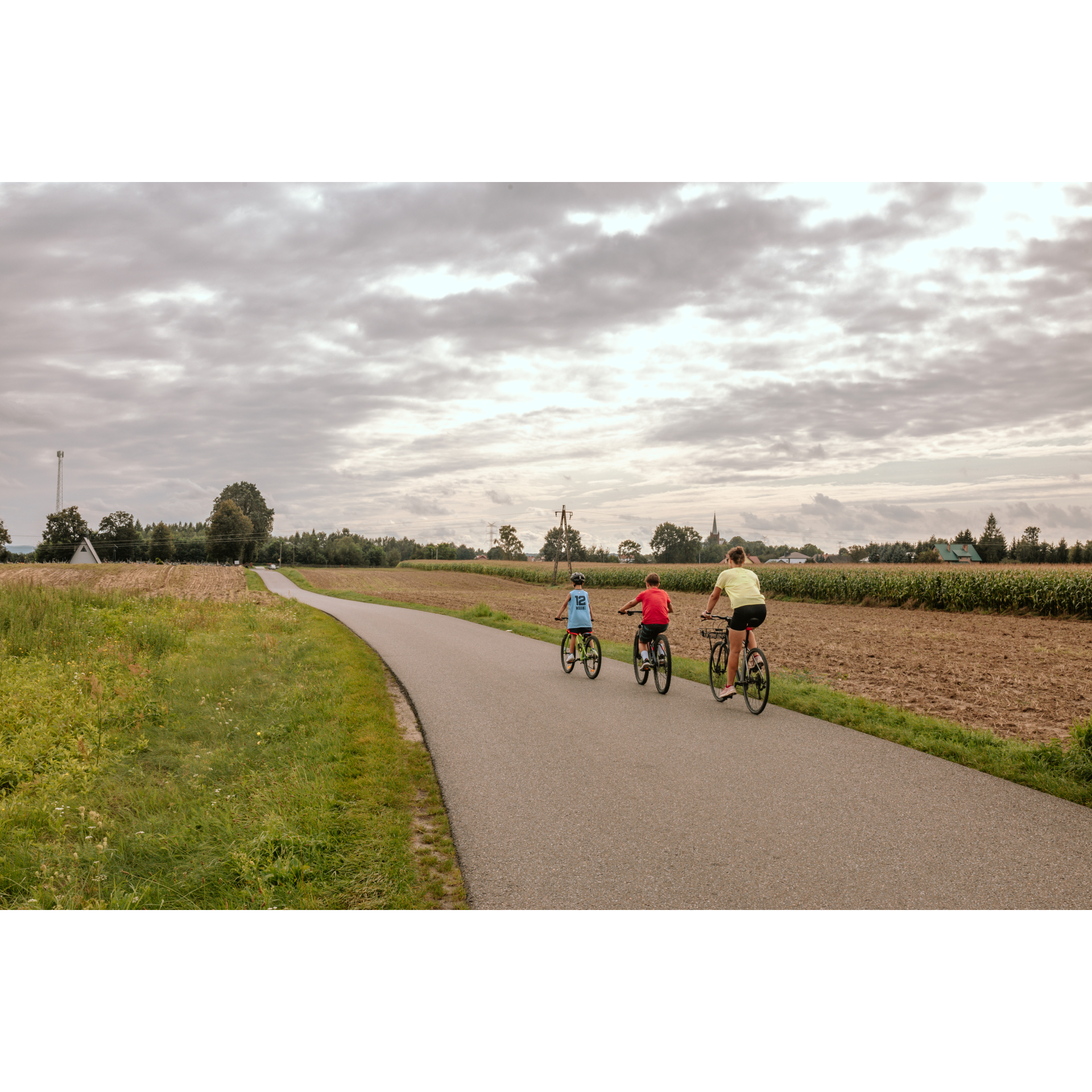 Cyclists on an asphalt dirt road