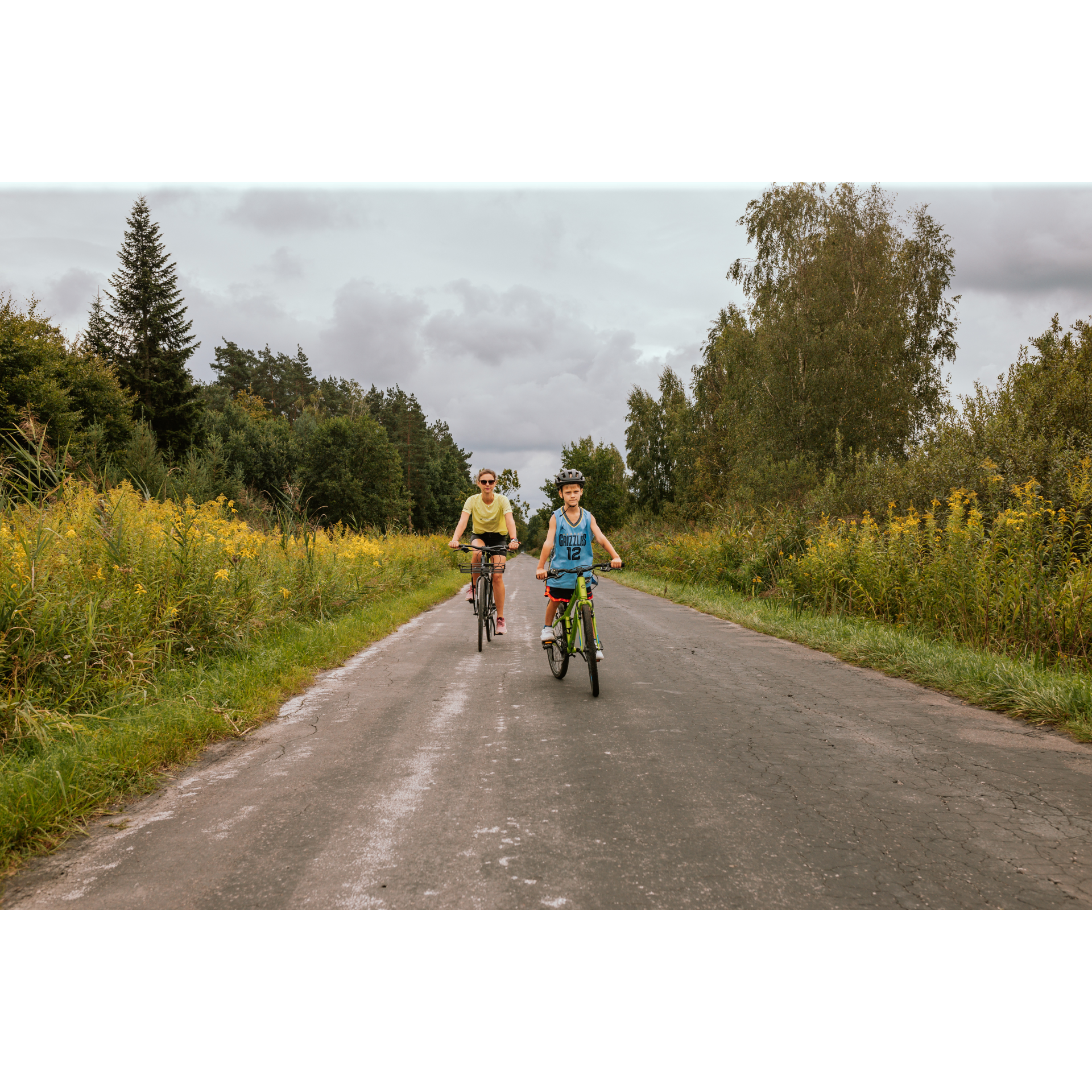 A cyclist and a child in colorful T-shirts