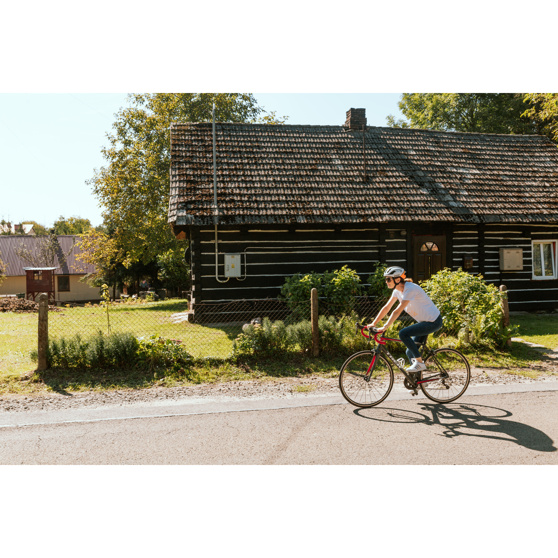 Cyclist and wooden house