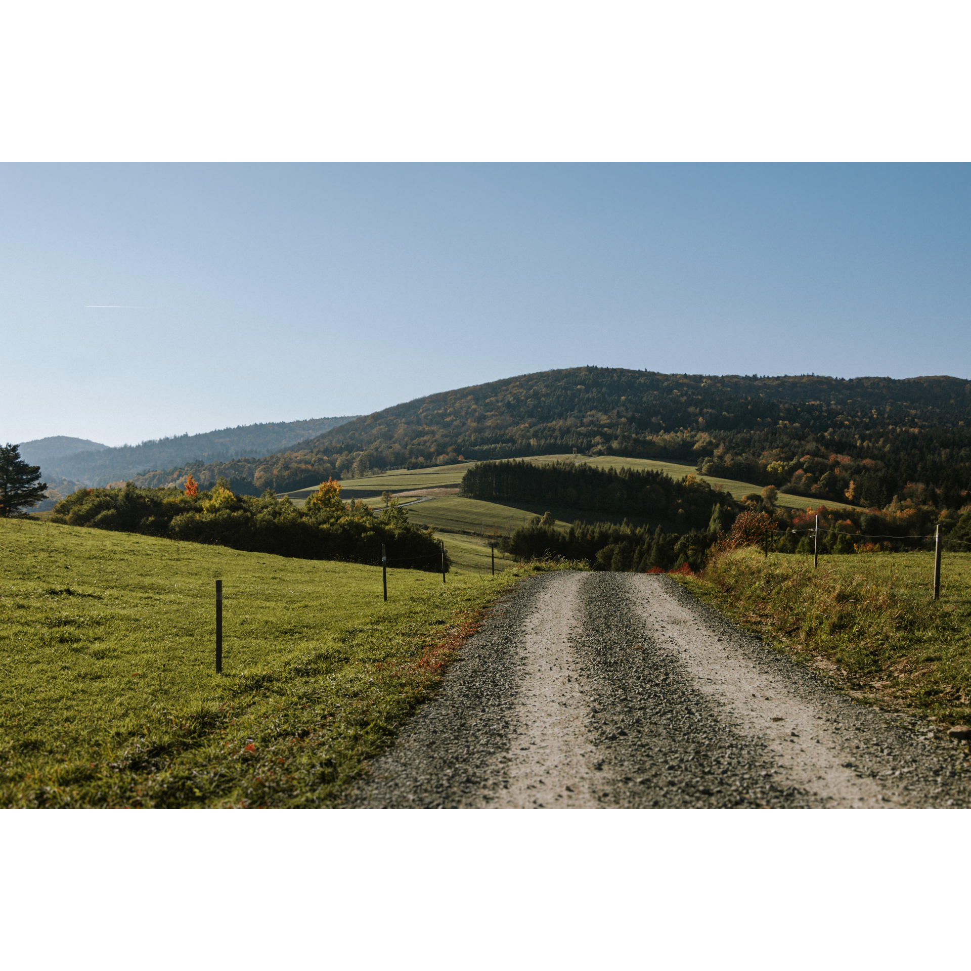 Dirt road on the background of green hills