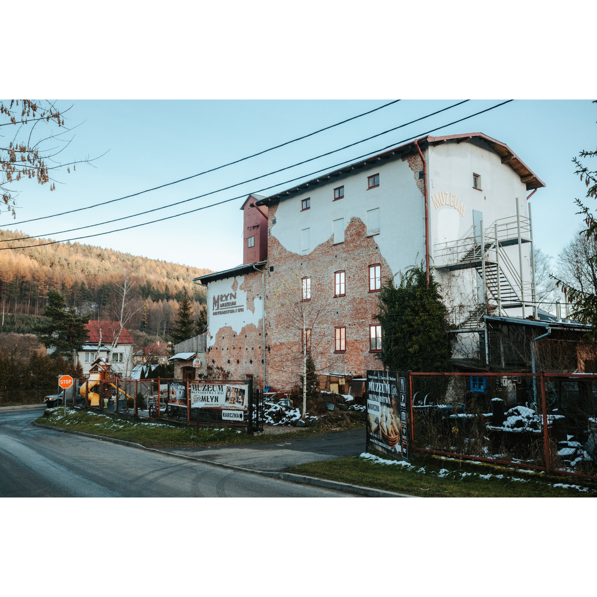 Destroyed white brick building with peeling plaster and visible brick