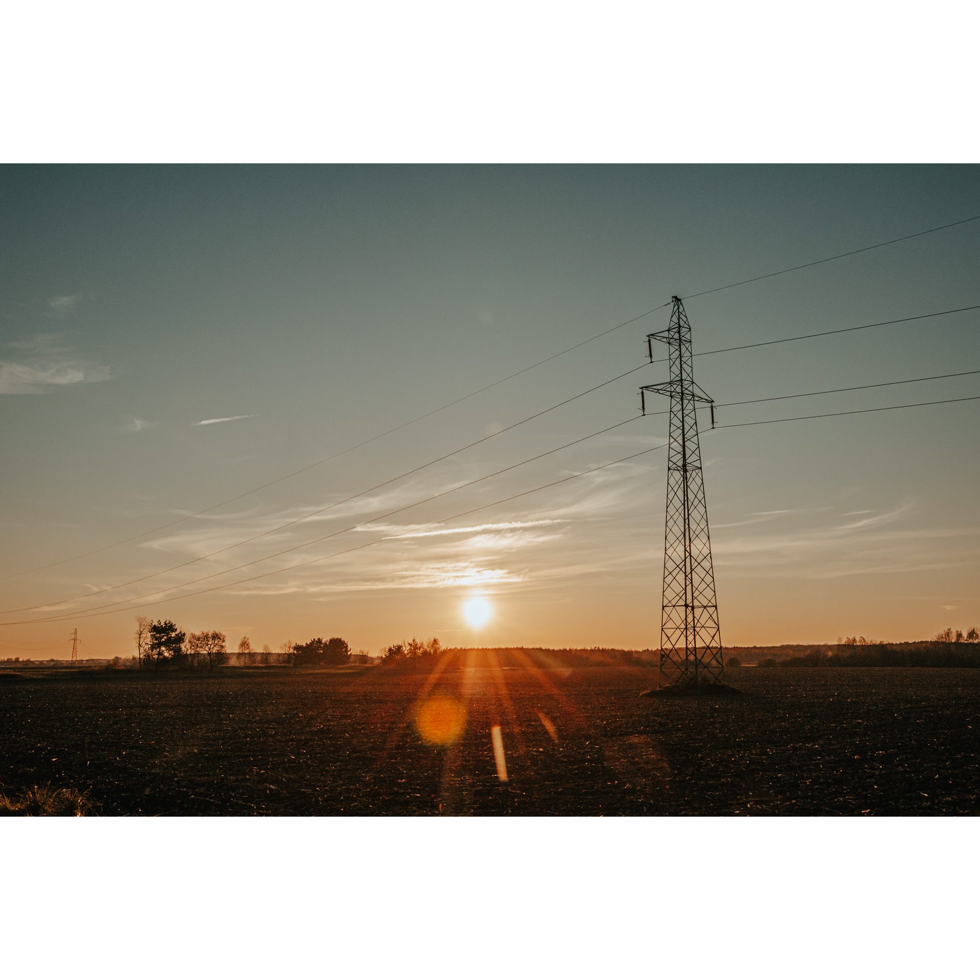 Support structure in an empty clearing at sunset