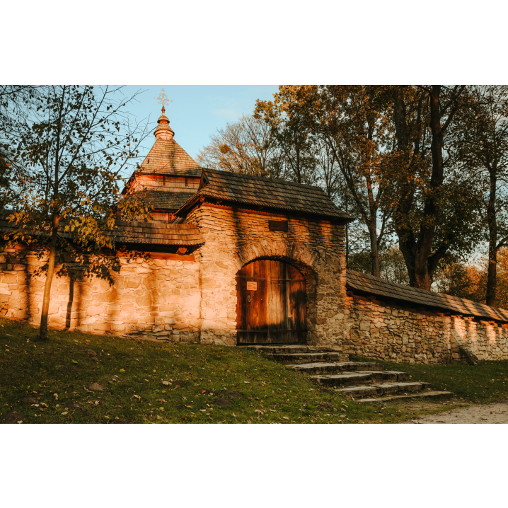 Stone gate with wooden door and roof and stone stairs