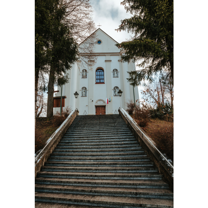 Wide stone steps leading to the entrance of a large white church with a triangular façade