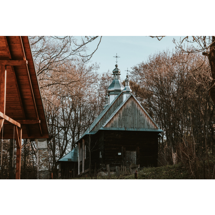 Wooden church among autumn trees