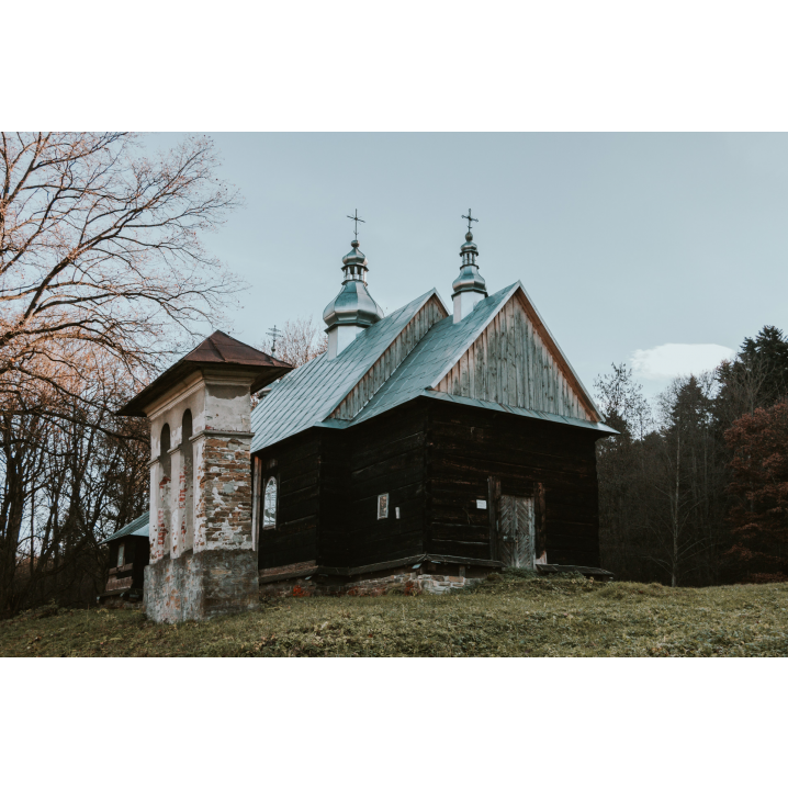 A wooden church with an old brick bell tower