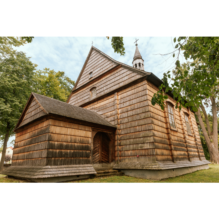 Wooden church among green trees