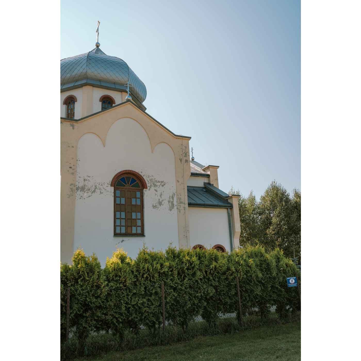 The church tower is in the shape of a drum, covered with an onion-shaped dome