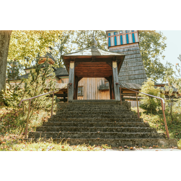 Wooden covered gate with a pole structure and concrete stairs