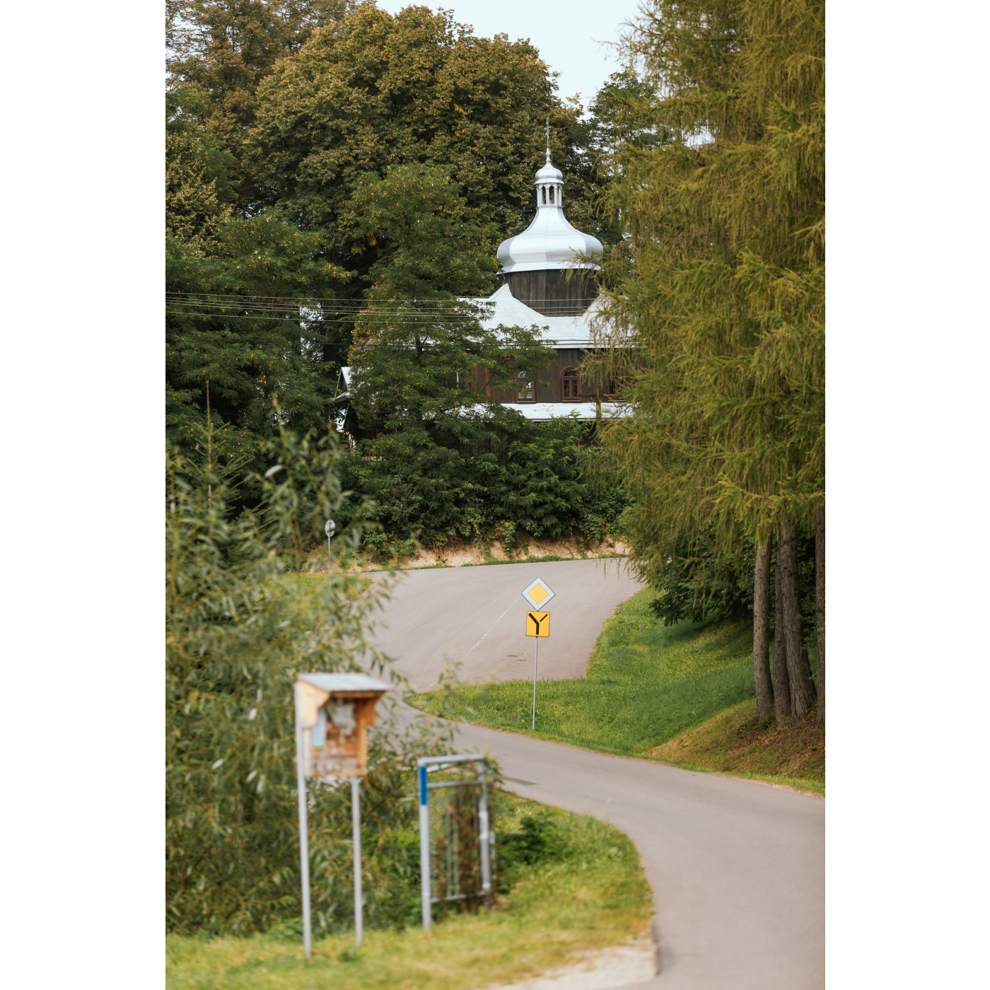 An Orthodox church emerging from behind the trees